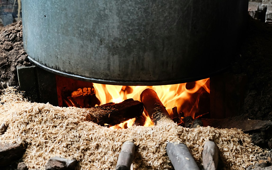 Close-up of a biomass furnace burning wood pellets and logs