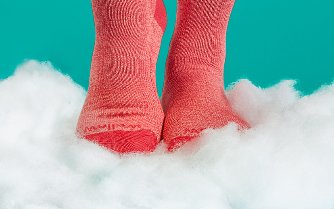 Wellow compression socks resting on a cloud of bamboo fibre